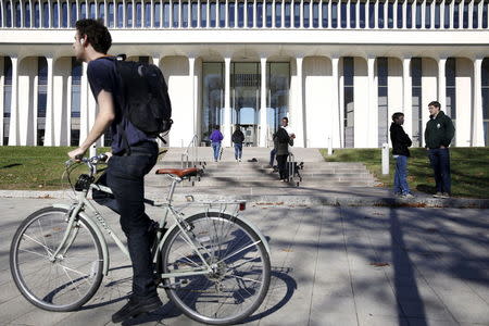 A cyclist rides past Princeton University's Woodrow Wilson School of Public and International Affairs in Princeton, New Jersey, November 20, 2015. REUTERS/Dominick Reuter