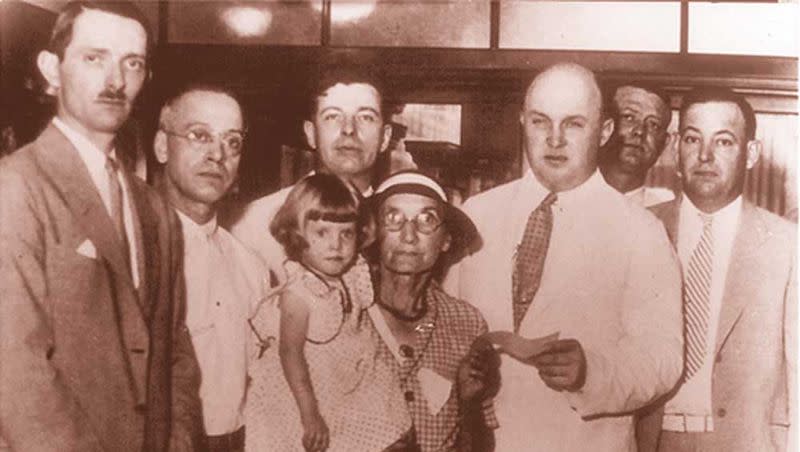 66-year-old Lydia Lobsiger receives an FDIC check for all her money on July 5, 1934, after the Fond Du Lac bank failed.