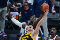 Illinois center Kofi Cockburn, top, blocks a shot over Iowa center Luka Garza, bottom, in the first half of an NCAA college basketball game at the Big Ten Conference tournament in Indianapolis, Saturday, March 13, 2021. (AP Photo/Michael Conroy)