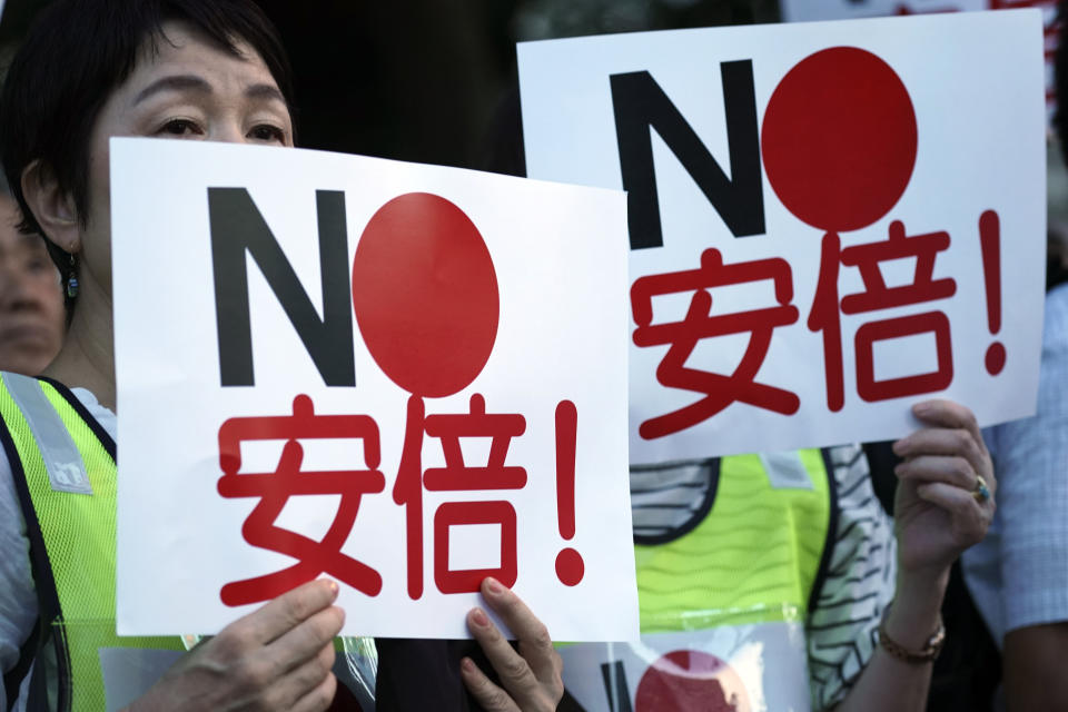 Protesters hold placards reading "No, Abe!" during a rally outside Japanese Prime Minister Shinzo Abe's residence in Tokyo Thursday, Aug. 8, 2019. More than 100 people staged a rally to urge the government to reverse the recent downgrading of South Korea's trade status and to apologize for wartime atrocities in an effort fix rapidly souring relations. (AP Photo/Eugene Hoshiko)