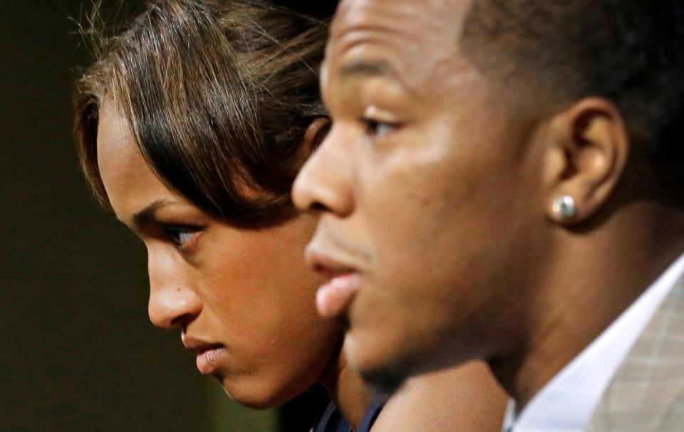 Janay Rice, left, looks on as her husband, Baltimore Ravens running back Ray Rice, speaks to the media during a news conference in Owings Mills, Md.