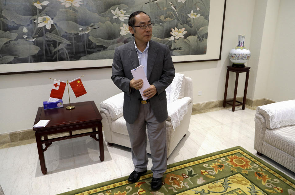 In this April 9, 2019, photo, China's ambassador to Tonga, Wang Baodong, waits to speak to The Associated Press at the embassy in Nuku'alofa, Tonga. China is pouring billions of dollars in aid and low-interest loans into the South Pacific, and even in the far-flung kingdom of Tonga there are signs that a battle for power and influence among much larger nations is heating up and could exact a toll. (AP Photo/Mark Baker)