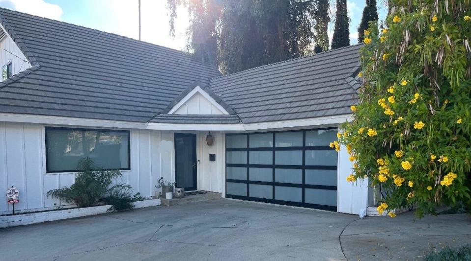 A modern home with a glass garage door.