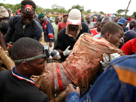 A rescued artisanal miner is carried from a pit as retrieval efforts proceed for trapped illegal gold miners in Kadoma, Zimbabwe, February 16, 2019. REUTERS/Philimon Bulawayo