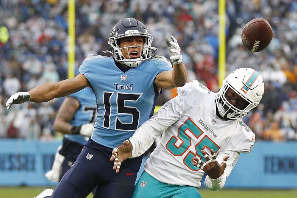 Tennessee Titans wide receiver Nick Westbrook-Ikhine (15) can't hang onto a pass as he is defended by Miami Dolphins outside linebacker Jerome Baker (55) in the first half of an NFL football game Sunday, Jan. 2, 2022, in Nashville, Tenn. (AP Photo/Wade Payne)