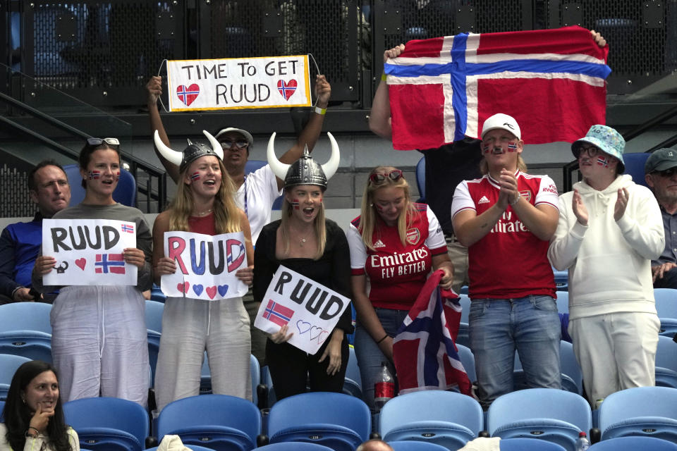 Supporters of Casper Ruud of Norway react during his second round match against Jenson Brooksby of the U.S. at the Australian Open tennis championship in Melbourne, Australia, Thursday, Jan. 19, 2023. (AP Photo/Dita Alangkara)