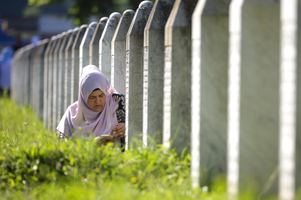A Bosnian Muslim woman prays next to the grave of her relative, victim of the Srebrenica massacre, at the Srebrenica Memorial Centre in Potocari, Bosnia, Thursday, July 11, 2024. Thousands gather in the eastern Bosnian town of Srebrenica to commemorate the 29th anniversary of the Srebrenica massacre, Europe’s only acknowledged genocide since the Holocaust. (AP Photo/Armin Durgut)