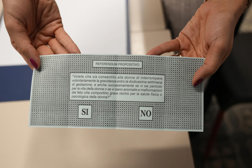 A woman shows her ballot for the abortion referendum at a polling station in San Marino, Sunday, Sept. 26, 2021. Tiny San Marino is one of the last countries in Europe which forbids abortion in any circumstance — a ban that dates from 1865. Its citizens are voting Sunday in a referendum calling for abortion to be made legal in the first 12 weeks of pregnancy. (AP Photo/Antonio Calanni)