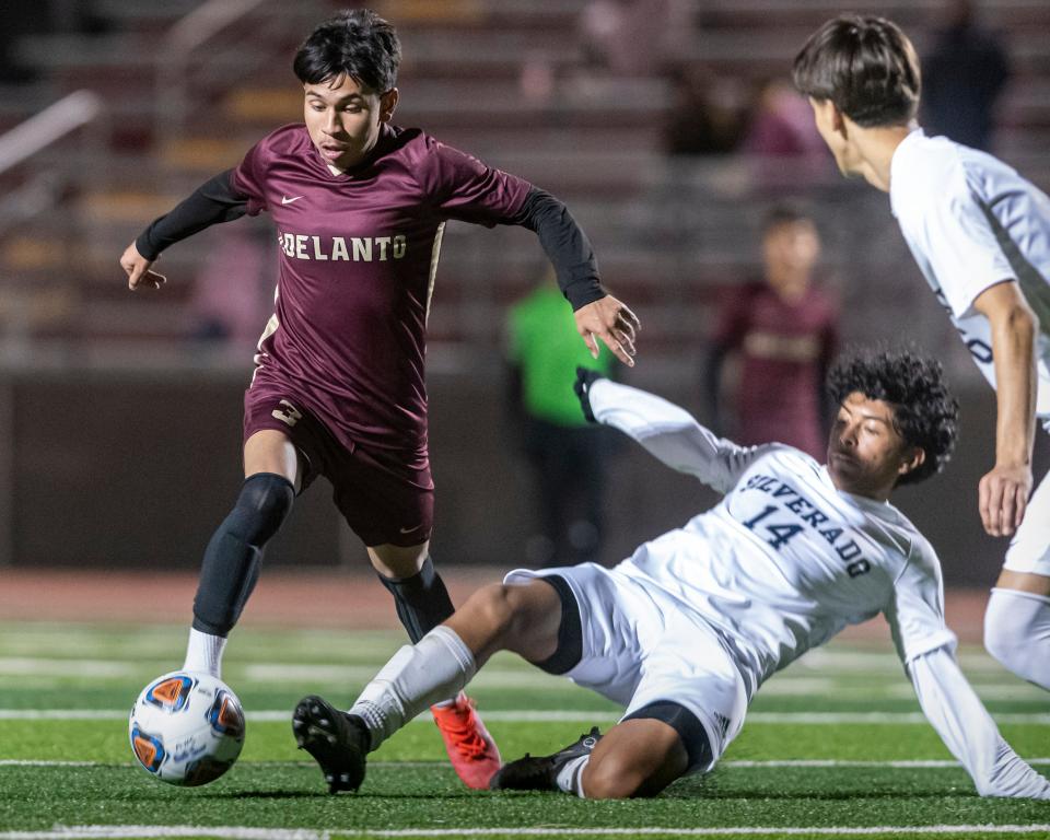 Adelanto’s Damian Espinoza, left, dribbles past Silverado’s Josue Martinez during the first half on Friday, Jan. 13, 2023.