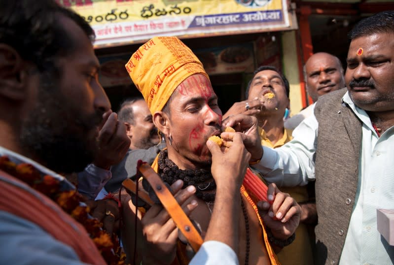 Hindu devotees celebrate after Supreme Court's verdict on a disputed religious site, in Ayodhya