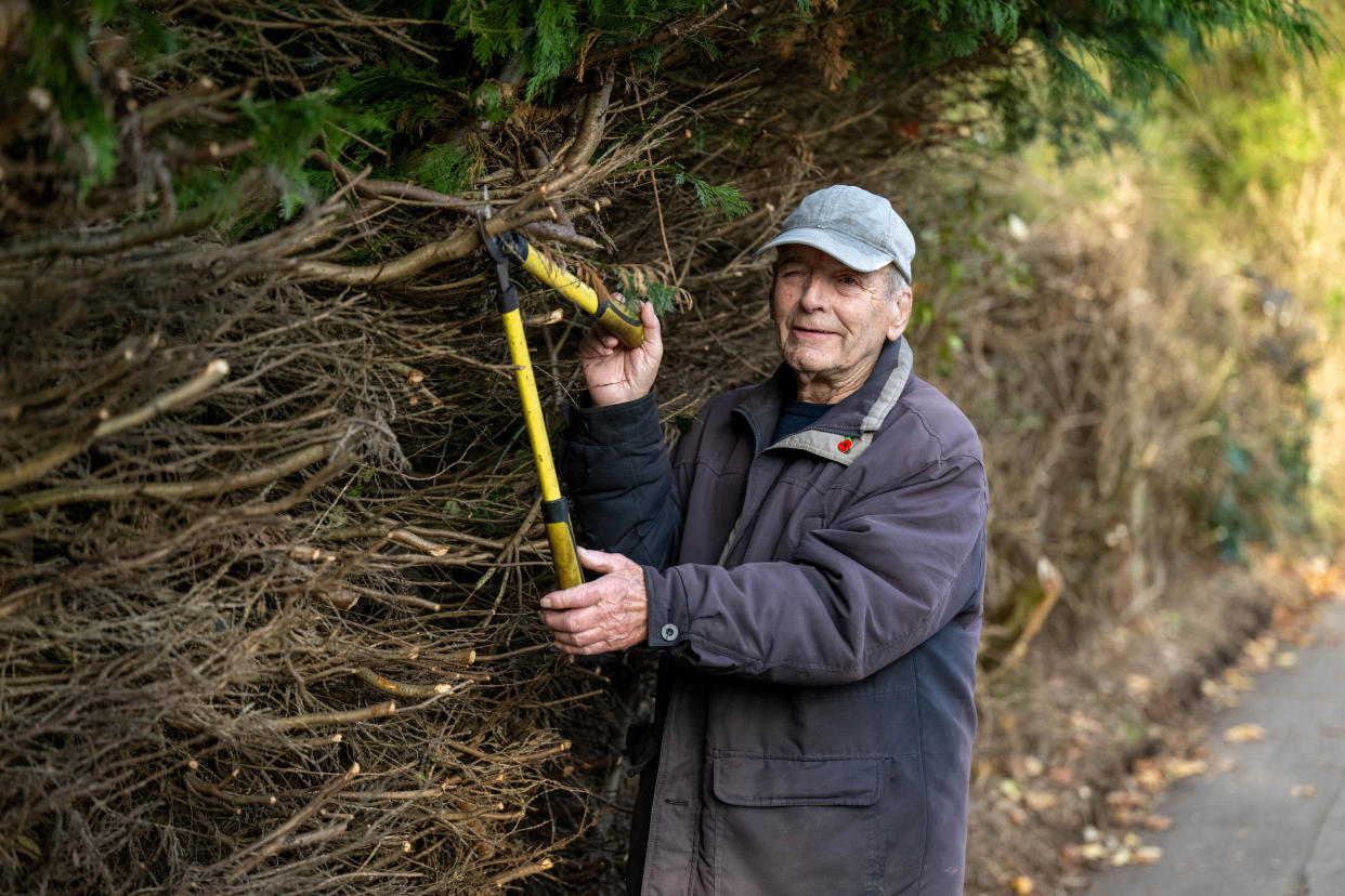 Keith Haines 89. Keith has cut back a hedge on a public footpath that has caused mixed responses from locals. Photo released November 8 2023. See SWNS story SWLShedges. A man cut his neighbours' hedges to clear a path because they 'hadn't bothered' then wrote to his local paper to 'thank me' - but not all residents are happy. Keith Haines, 89, has divided opinion after cutting back a hedgerow to make a path more accessible to pedestrians and wheelchair users. He claims to have informed the local council of his plans to trim the hedge - and was not stopped from doing so because they are in private property. Keith, of Newbury, Berks, then 'thanked himself' for cutting away the foliage. 