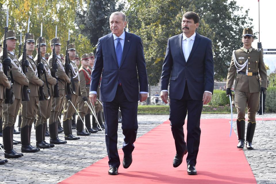 Turkish President Recep Tayyip Erdogan, left, and his Hungarian counterpart Janos Ader review the honour guards during the welcoming ceremony in front of the presidential Alexander Palace in Budapest, Hungary, Monday, Oct. 8, 2018. Erdogan is paying a two-day official visit to Hungary. (Zoltan Mathe/MTI via AP)