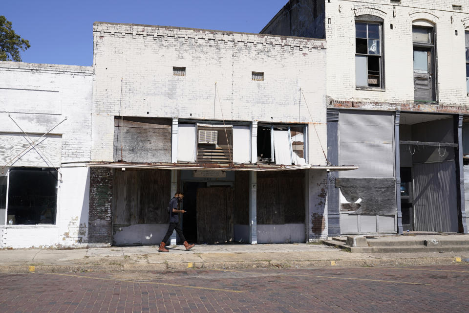 Vacant, unkept and weather worn store fronts line a street in downtown Itta Bena, Miss., Thursday, Oct. 22, 2020. Area residents believe the high price of electricity provided by the city as one of the reasons for store closures. (AP Photo/Rogelio V. Solis)