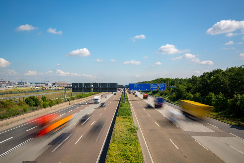 Multilane Autobahn highway with blurred trucks and cars near Frankfurt Airport, Frankfurter Kreuz, Germany