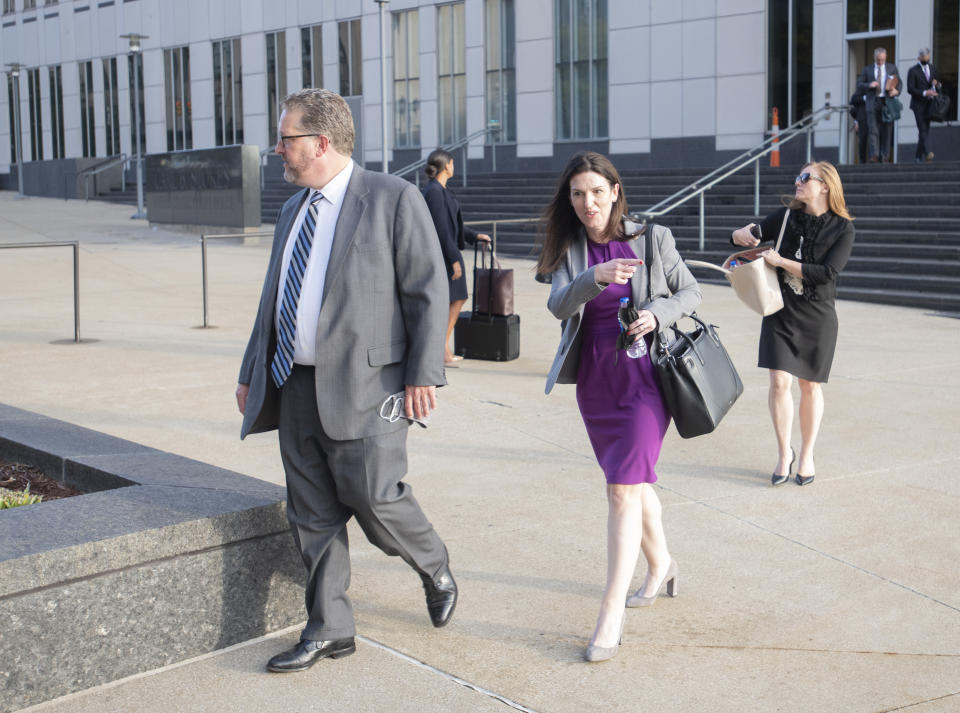 FILE - Attorneys and staff associated with a federal trial of pharmacies, CVS, Walgreens, Giant Eagle and Walmart, leave the Carl B. Stokes Federal Courthouse in Cleveland, Monday, Oct. 4, 2021. The pharmacies are being sued by Ohio counties Lake and Trumbull for their part in the opioid crisis. Pittsburgh-based Giant Eagle, one of the four retail pharmacy companies on trial for their alleged roles in fostering an opioid crisis in two Ohio counties announced Friday, Oct. 29, 2021 it had settled lawsuits filed by 10 government entities in the state that have accused the companies of creating a public nuisance. (AP Photo/Phil Long, File)