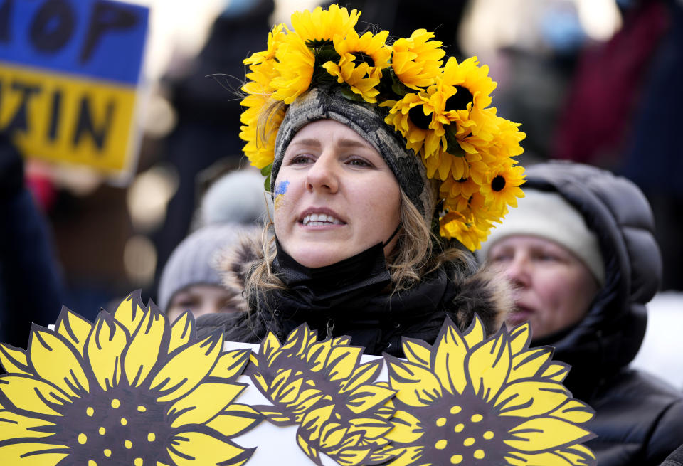 A person wears a crown of sunflowers as they rally against Russia's invasion of Ukraine during a protest outside City Hall in Ottawa, Ontario, Sunday, Feb. 27, 2022. (Justin Tang/The Canadian Press via AP)