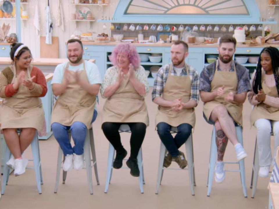 bakers from season 13 of bake off sitting on stools