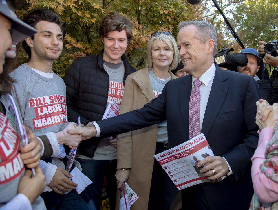Australian Labor Party leader Bill Shorten, right, shakes hands with supporters at a polling station for a federal election in Melbourne, Australia, Saturday, May 18, 2019. Political leaders continued frenetic 11th-hour campaigning as Australians vote on Saturday in an election likely to deliver the nation's sixth prime minister in as many years. (AP Photo/Andy Brownbill)