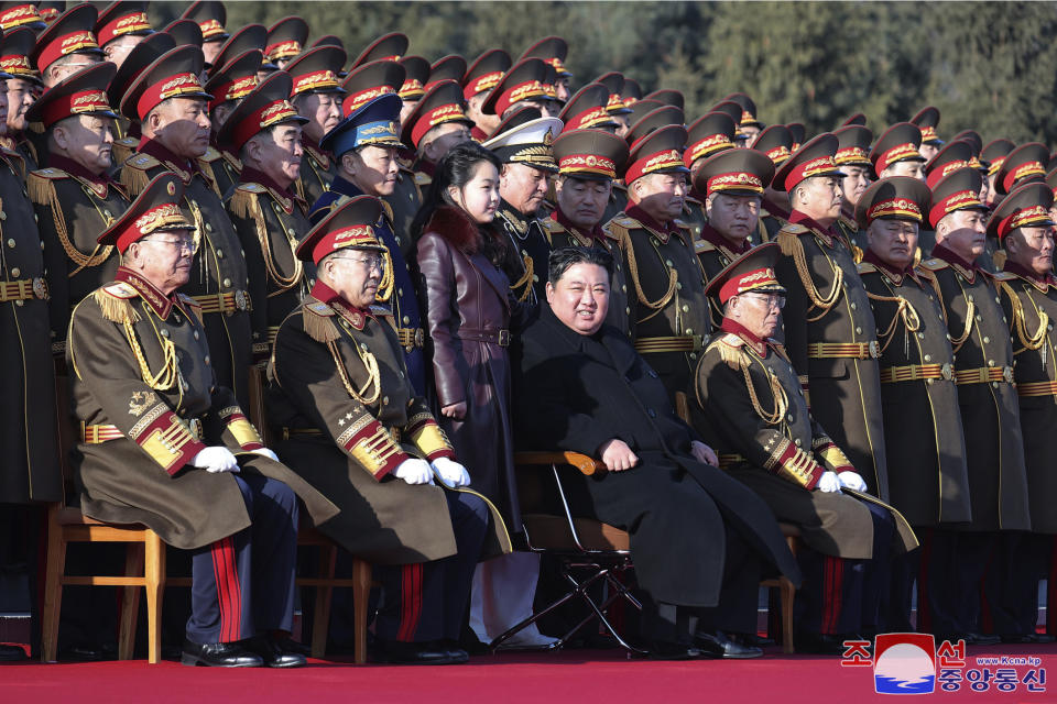 In this photo provided by the North Korean government, its leader Kim Jong Un, second right, front row, with his daughter, poses for a photo with officers of the defense ministry during celebrations for the 76th founding anniversary of the country's army in North Korea, Thursday, Feb. 8, 2024. Independent journalists were not given access to cover the event depicted in this image distributed by the North Korean government. The content of this image is as provided and cannot be independently verified. Korean language watermark on image as provided by source reads: "KCNA" which is the abbreviation for Korean Central News Agency. (Korean Central News Agency/Korea News Service via AP)