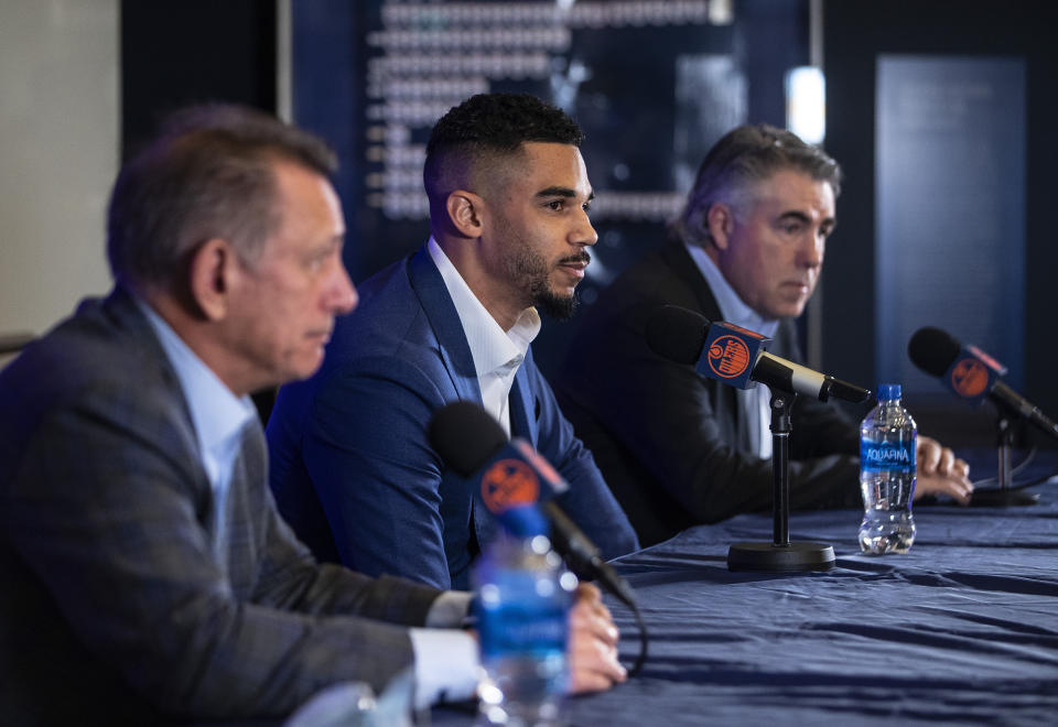 Edmonton Oilers general manager Ken Holland, left, Evander Kane and head coach Dave Tippet announce Kane's signing in Edmonton Alberta, Friday, Jan. 28, 2022. (Jason Franson/The Canadian Press via AP)