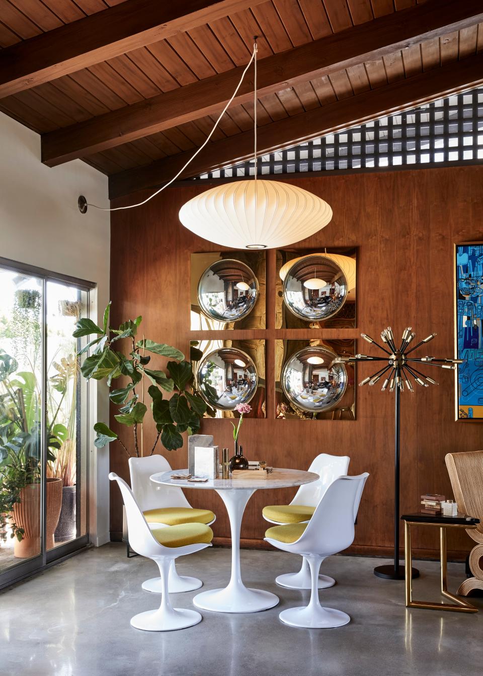 One of many dining areas is complete with a Knoll Saarinen dining table and chairs. “We wanted everything to be vintage or a replica,” says Colman of his design approach.