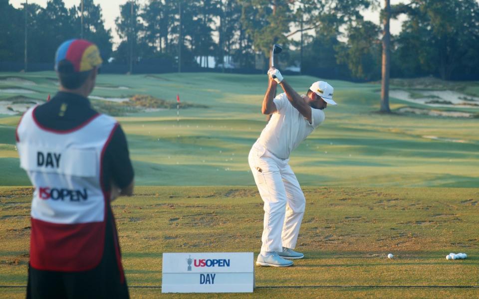 Jason Day of Australia warms up on the range during the second round