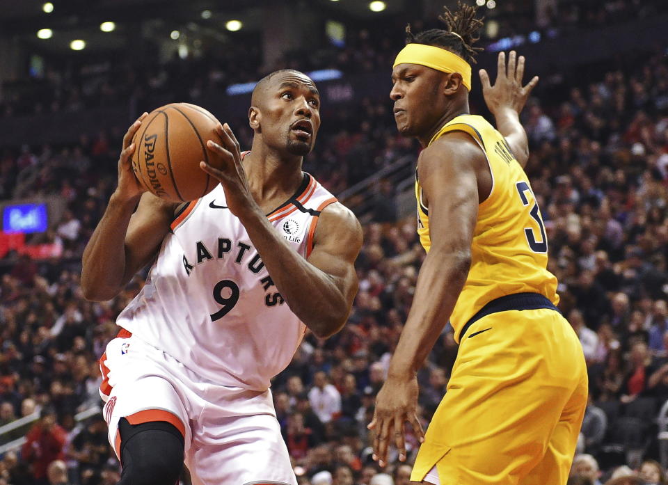 Toronto Raptors center Serge Ibaka (9) drives against Indiana Pacers center Myles Turner (33) during first-half NBA basketball game action in Toronto, Sunday, Feb. 23, 2020. (Frank Gunn/The Canadian Press via AP)