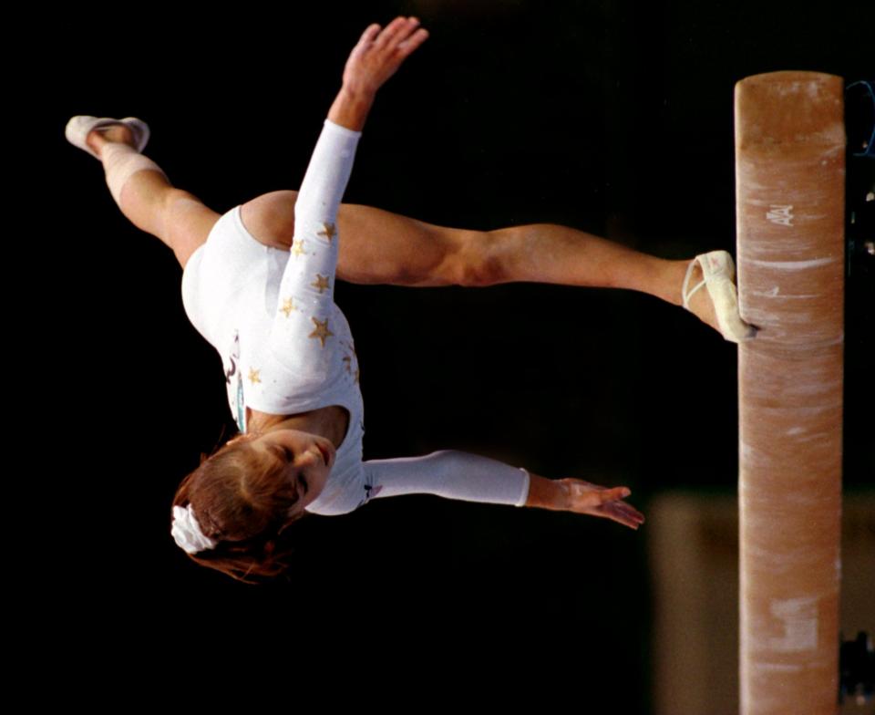 ATLANTA - JULY 25: U.S. gymnast Dominique Moceanu almost falls of the balance beam while performing her routine in the women's gymnastics competition during the 1996 Summer Olympic Games in Atlanta, Ga. She scored a 9.6. (Photo by Jim Davis/The Boston Globe via Getty Images)