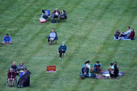 People are socially distanced as they listen to music of the Kansas City Symphony on the lawn at the Liberty Memorial Saturday, Sept. 19, 2020, in Kansas City, Mo. (AP Photo/Charlie Riedel)