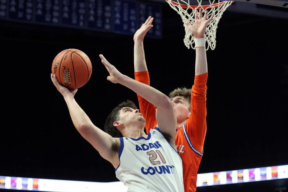 Adair County’s Brayton Coomer (21) fought off Marshall County’s Ryan Stokes on Wednesday night. Coomer finished with 10 points and four rebounds.