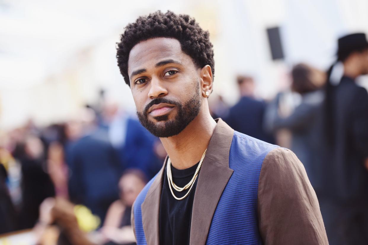 Big Sean looks amazing in this brown and blue color suit with inner black round-neck shirt and pant to match