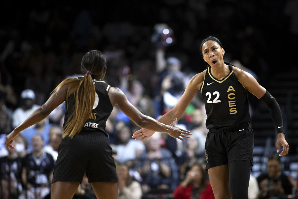 Las Vegas Aces forward A'ja Wilson (22) celebrates with guard Jackie Young (0) after scoring during the first half of Game 2 of a WNBA basketball playoff series game against the Chicago Sky, Sunday, Sept. 17, 2023, in Las Vegas. (Ellen Schmidt/Las Vegas Review-Journal via AP)