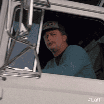 A trucker looks out of his window, looking bewildered