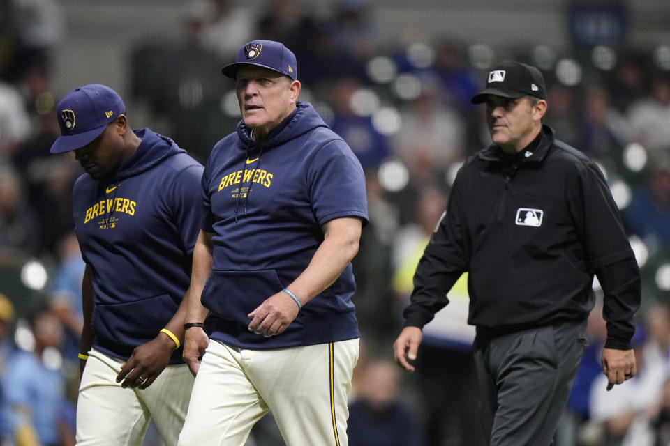 Milwaukee Brewers manager Pat Murphy, middle, walks back to the dugout with Rickie Weeks Jr., left, after being ejected during the sixth inning of a baseball game against the Tampa Bay Rays Tuesday, April 30, 2024, in Milwaukee. (AP Photo/Aaron Gash)