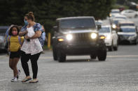 Students arrive to Dallas Elementary School for the first day of school amid the coronavirus outbreak on Monday, Aug. 3, 2020, in Dallas, Ga. (AP Photo/Brynn Anderson)