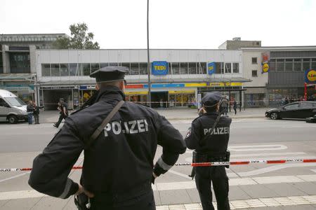 Police officers look on after a knife attack in a supermarket in Hamburg, Germany, July 28, 2017. REUTERS/Morris Mac Matzen