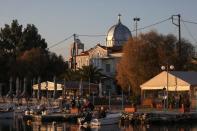 Locals fish at the village of Panagiouda across the Mavrovouni camp on the island of Lesbos