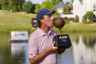 Stephen Ames kisses the trophy as he poses for the media after winning the Mitsubishi Classic senior golf tournament at TPC Sugarloaf on Sunday, April 28, 2024, in Duluth, Ga. (Miguel Martinez/Atlanta Journal-Constitution via AP)