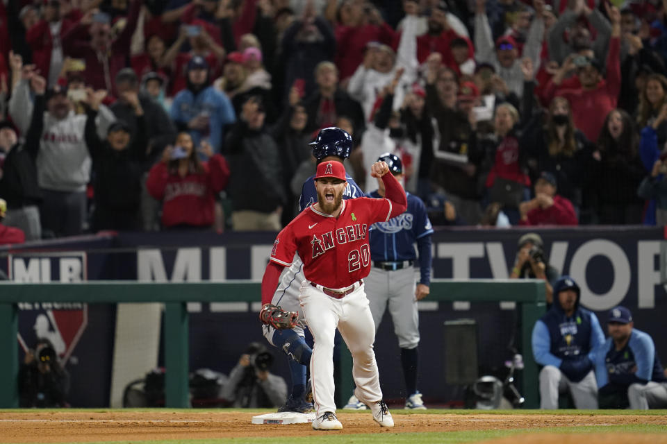 Los Angeles Angels first baseman Jared Walsh (20) celebrates after catching a throw to first to out Tampa Bay Rays' Yandy Diaz (2) during the ninth inning of a baseball game in Anaheim, Calif., Tuesday, May 10, 2022. The out secured a no hitter for starting pitcher Reid Detmers (48). (AP Photo/Ashley Landis)