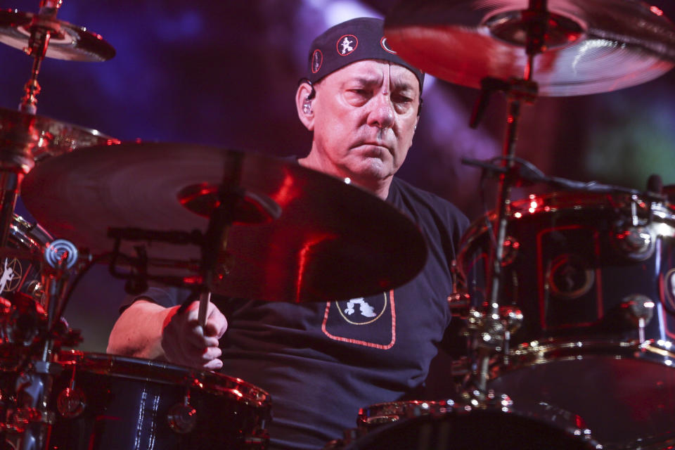 FILE - This Aug. 1, 2015 file photo shows Neil Peart of Rush performing during the final show of the R40 Tour in Los Angeles. Peart, the renowned drummer and lyricist from the band Rush, has died. His rep Elliot Mintz said in a statement Friday that he died at his home Tuesday, Jan. 7, 2020 in Santa Monica, Calif. He was 67. (Photo by Rich Fury/Invision/AP, File)