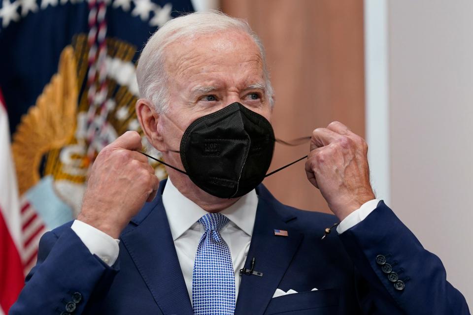 President Joe Biden removes his face mask as he arrives to speak about the economy during a meeting with CEOs in the South Court Auditorium on the White House complex in Washington on July 28, 2022.