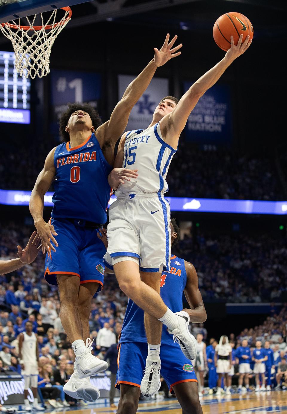 Kentucky's Reed Sheppard (15) put in a basket over Florida's Zion Pullin (0) during first half action as the Kentucky Wildcats battled the Florida Gators Wednesday night at Rupp Arena. Jan. 31, 2024