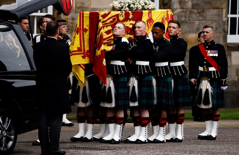 Queen Elizabeth’s grieving children watched as her coffin arrived in Edinburgh to lie in rest at the Palace of Holyroodhouse overnight credit:Bang Showbiz