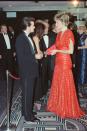 <p>Princess Diana rewore this red evening gown when she met Charlie Sheen at the London premiere of <em>Hot Shots</em>. Charlie kept it simple in a black tuxedo.</p>