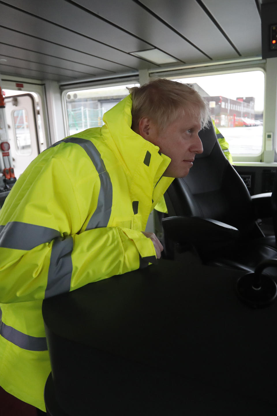 Britain's Prime Minister Boris Johnson looks out from the steering cabin of tug boat during a General Election campaign trail stop in the port of Bristol, England, Thursday, Nov. 14, 2019. Britain goes to the polls on Dec. 12. (AP Photo/Frank Augstein, Pool)