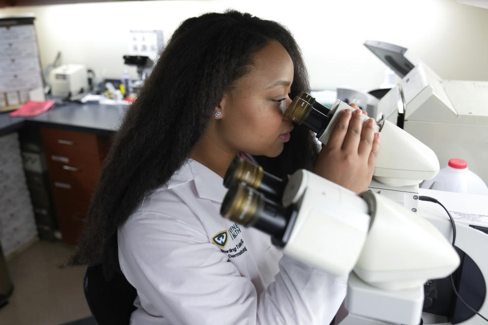 Dr. Starling Tolliver, a dermatology resident at Wayne State University, works at Wayne Health in Dearborn, Mich., Tuesday, Aug. 1, 2023. (AP Photo/Paul Sancya)