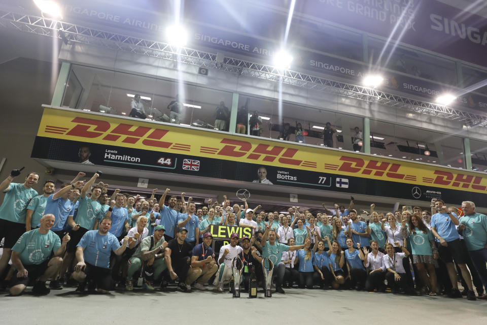 Team Mercedes poses after Lewis Hamilton of Britain, center, wins the Singapore Formula One Grand Prix at the Marina Bay City Circuit in Singapore, Sunday, Sept. 16, 2018. (AP Photo/Yong Teck Lim)