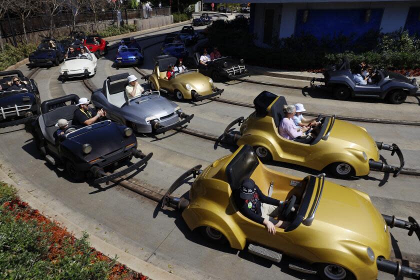 Anaheim, CA - March 11: Visitors wait in lines inside their idling cars at the end of the ride at Autopia in Tomorrowland at Disneyland. Environmental activists Zan Dubin and Paul Scott, not shown, recently filed a complaint about air pollution and noxious smells from Autopia with Southern California air quality regulators at Disneyland in Anaheim Monday, March 11, 2024. They want Disneyland to convert Autopia to electric vehicles, and to find other ways -in Tomorrowland and across the park - to bring clean energy into its storytelling. (Allen J. Schaben / Los Angeles Times)