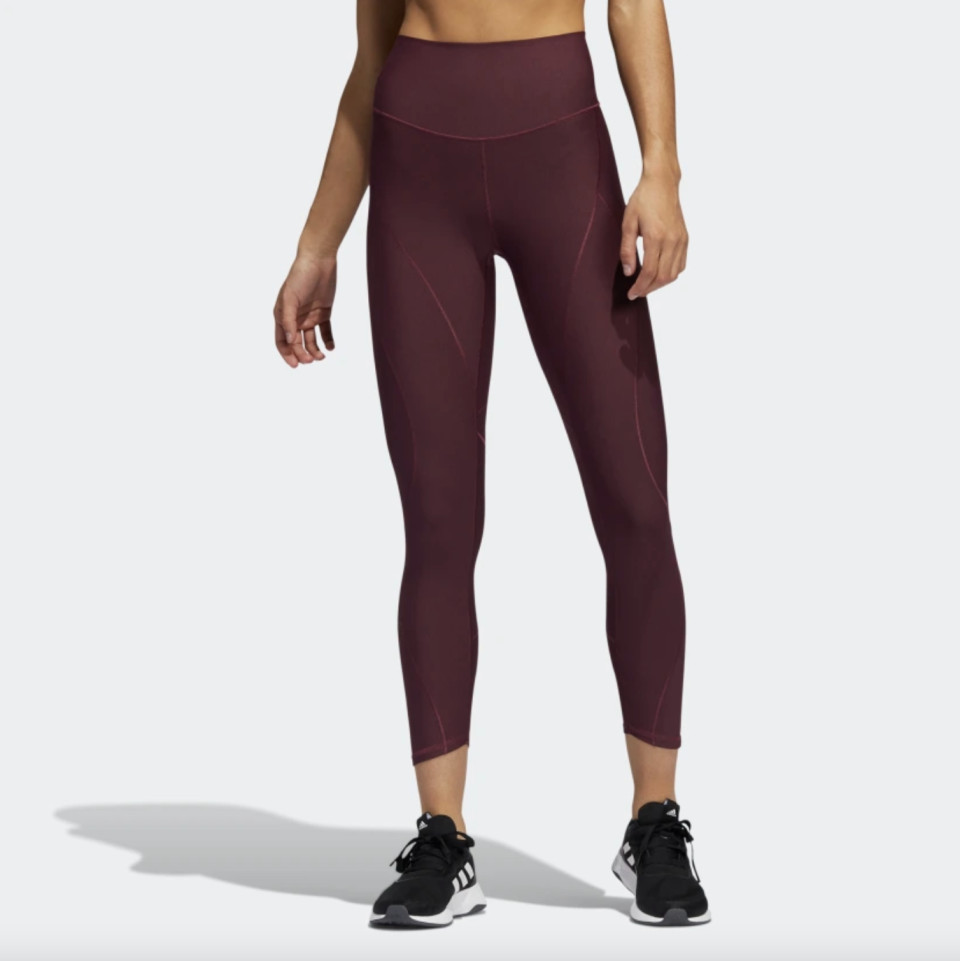 Yoga Primeblue 7/8 Tights in burgundy with black sneakers (Photo via Adidas)