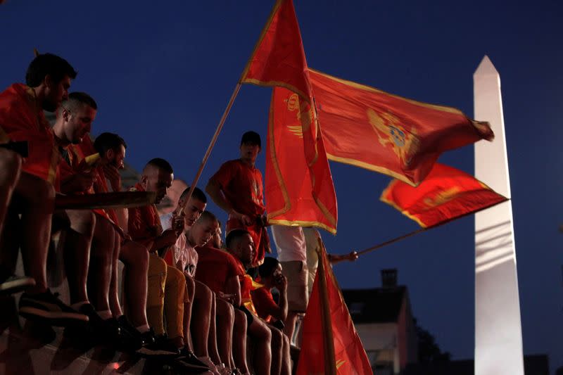 Self-described patriots wave flags during post-election rally in Podgorica